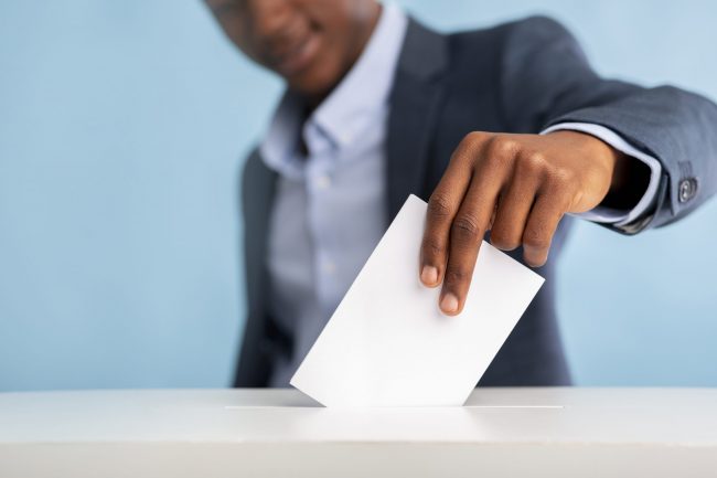 African man voted on president elections, blurred background
