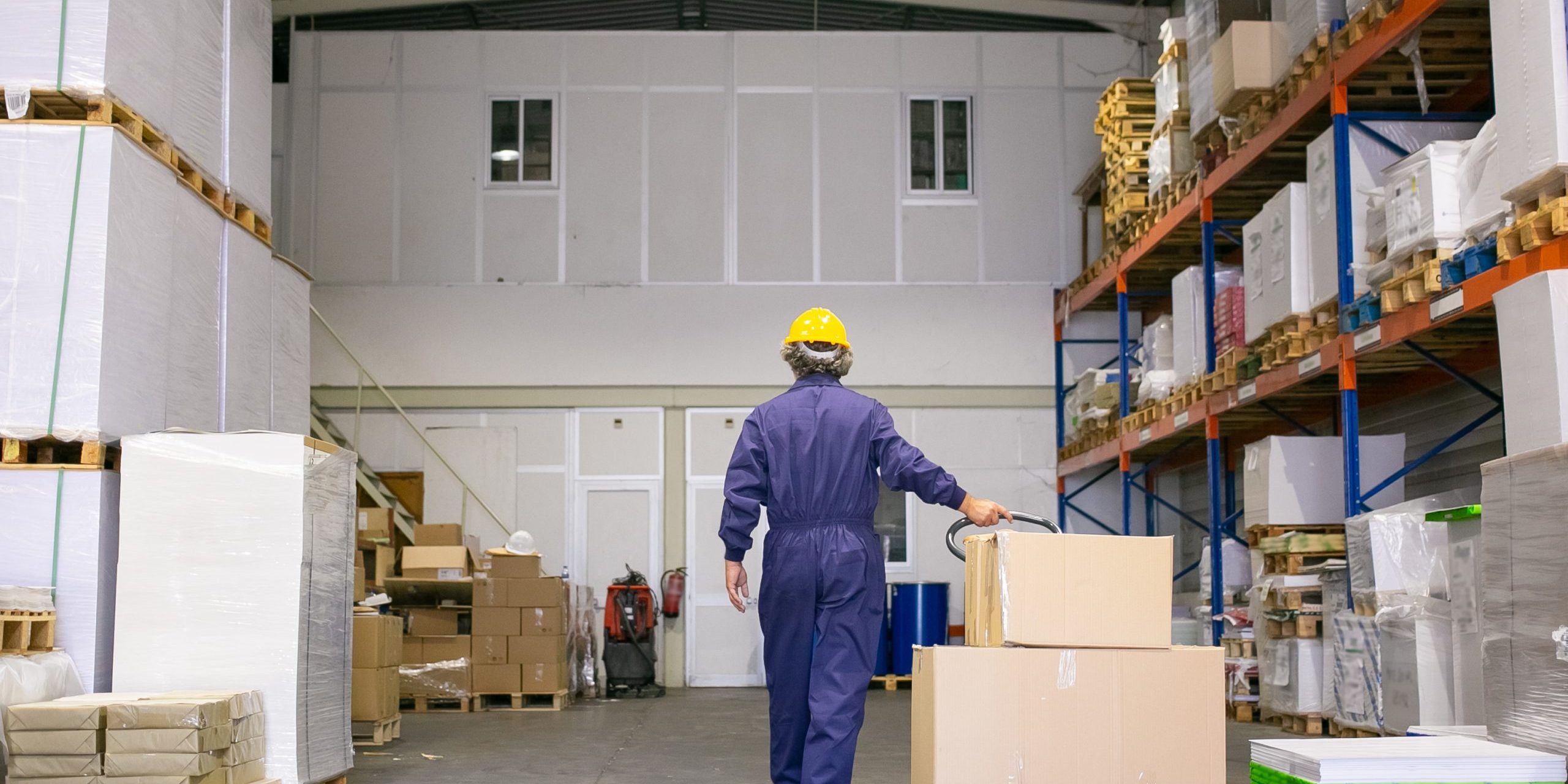 Senior logistic worker in hardhat and uniform