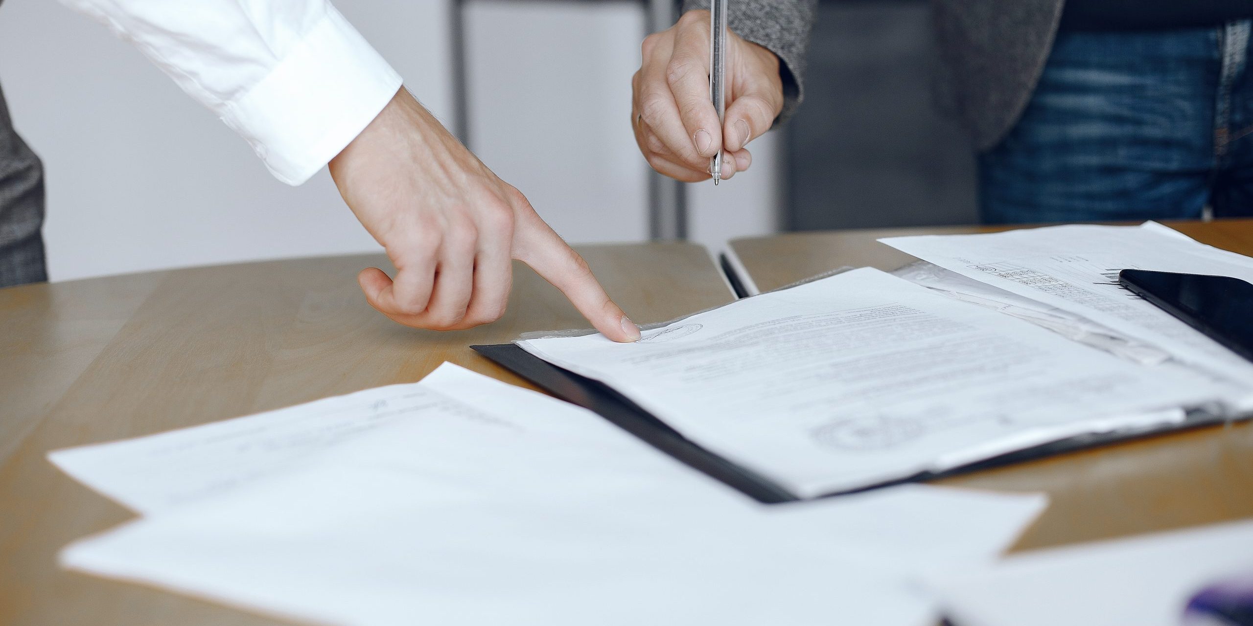 Two business partners signing a document