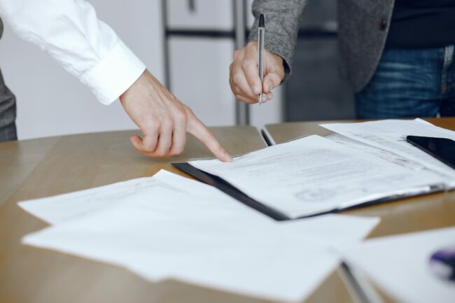 Two business partners signing a document