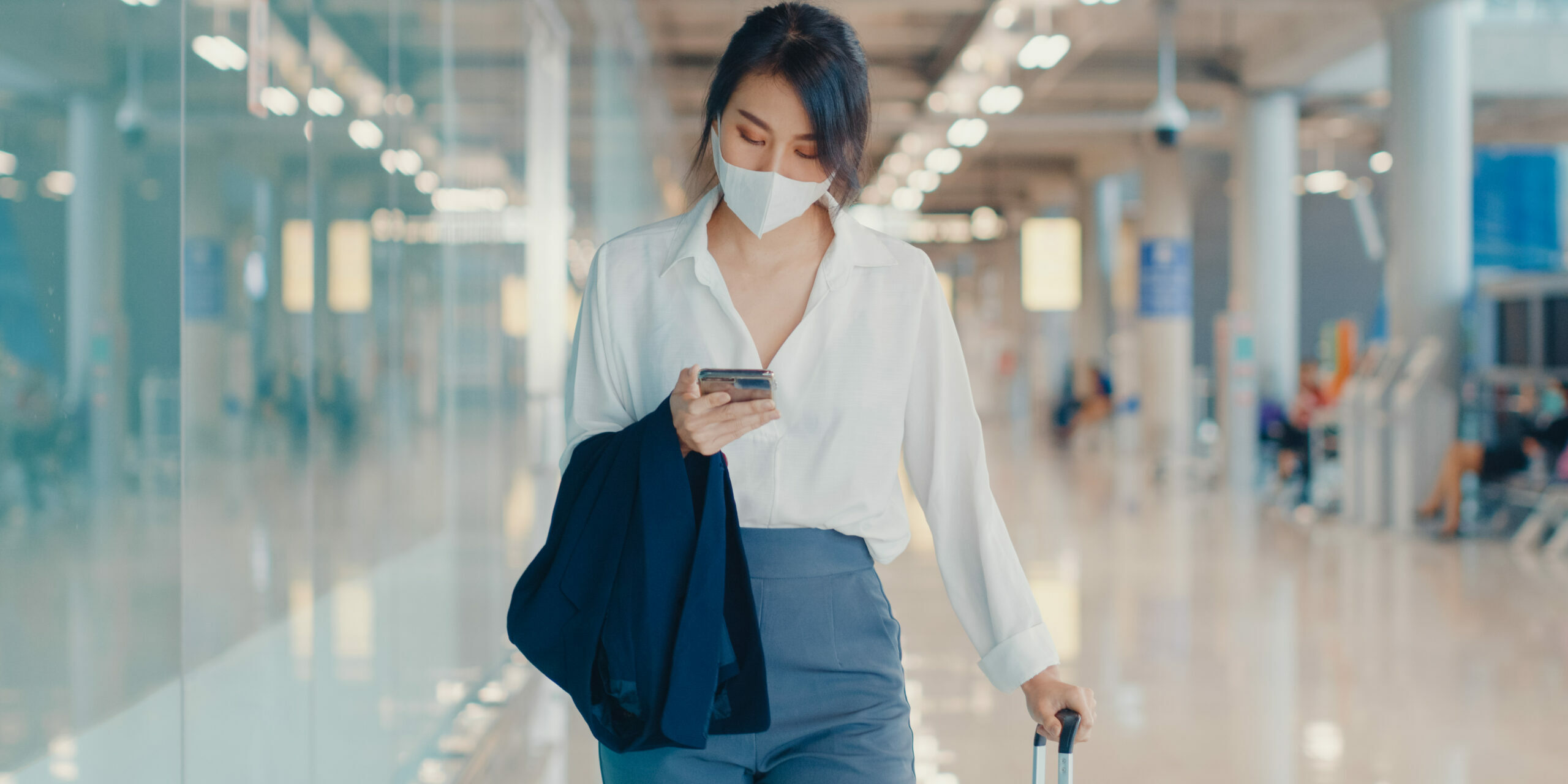 Asian business girl use smart phone for check in boarding pass w