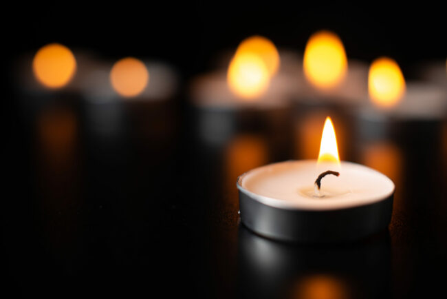 front-view-burning-candles-pitch-black-surface