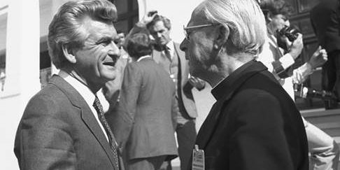 Prime Minister Bob Hawke talks to Archbishop James Carroll outside Parliament House during the Economic Summit in April 1983. National Archives of Australia, NAA: A6180, 15/4/83/5.