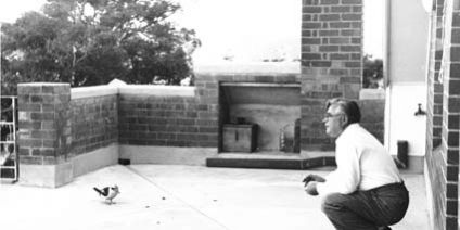 A kookaburra being fed by Vladimir Petrov on the verandah of the ‘safe house’ where he and his wife Evdokia Petrov were held following their defection to Australia. Photograph circa 1954 presented as evidence to the Royal Commission on Espionage, National Archives of Australia, Series/Control symbol A6285, 4.