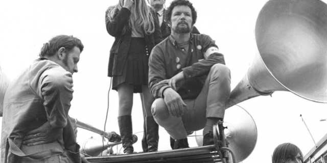 A woman addresses protestors, with Jim Cairns and George Coote, at the Vietnam War Moratorium Day, Melbourne, May 1970; picture by Tim Aickin; Trove, National Library of Australia, PIC Online access #PIC/14404/2.