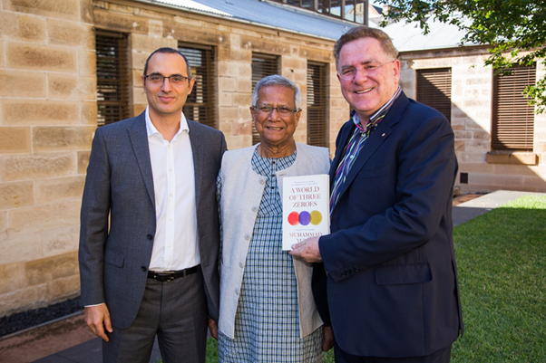 Adam Geha, Muhammad Yunus, and Michael Easson, with the book A World of Three Zeros.